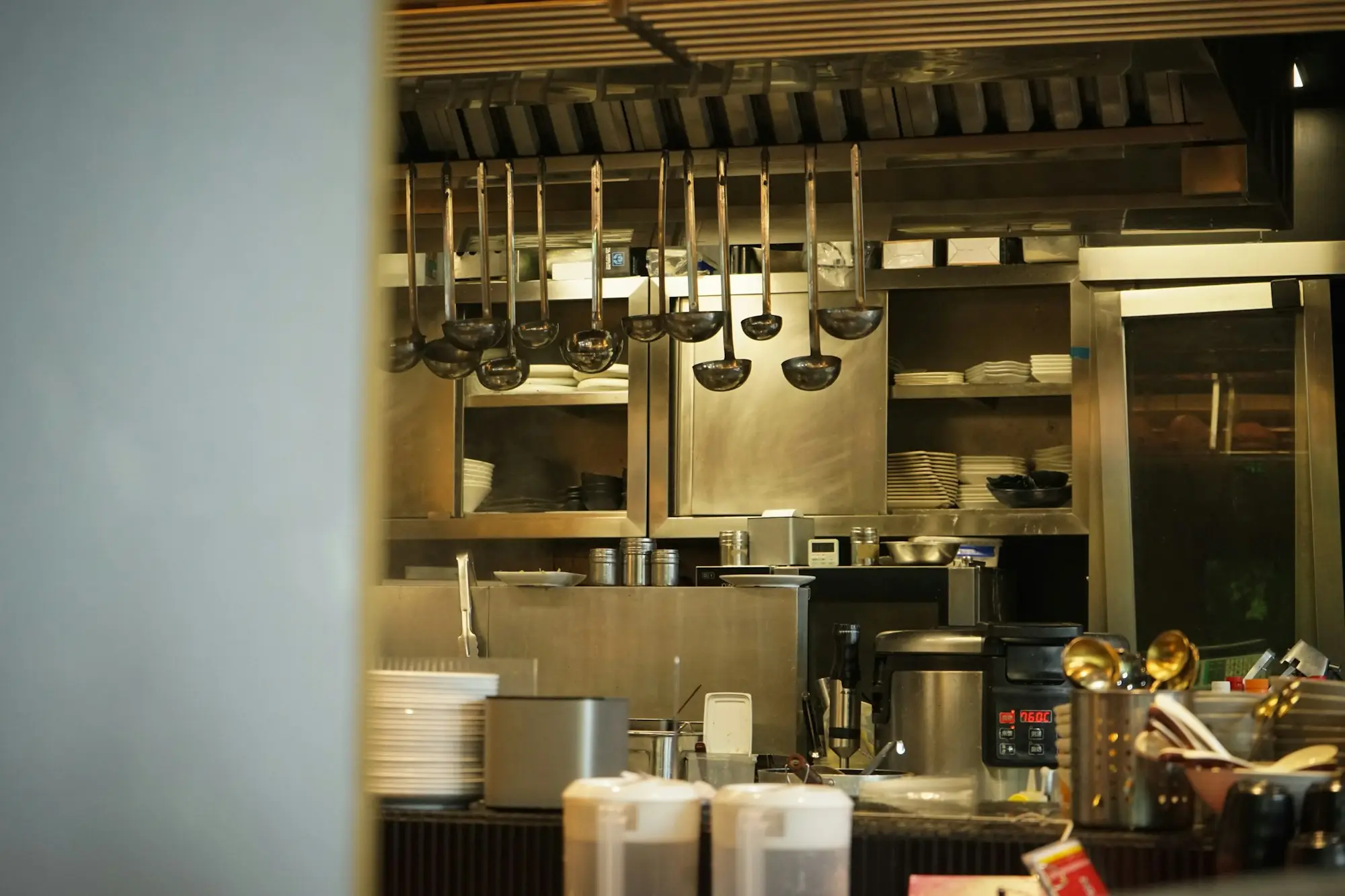 Commercial kitchen with stainless steel benches and equipment