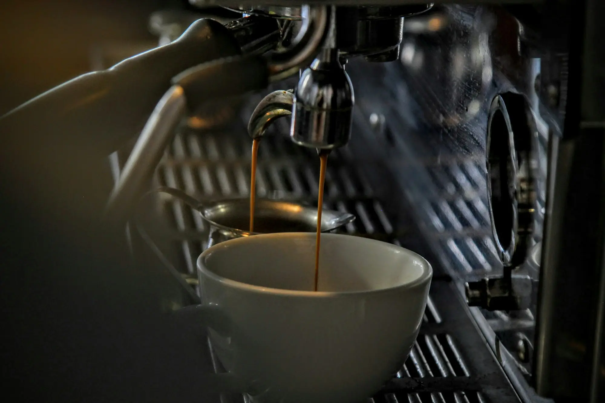 Barista using a commercial espresso machine on the Gold Coast
