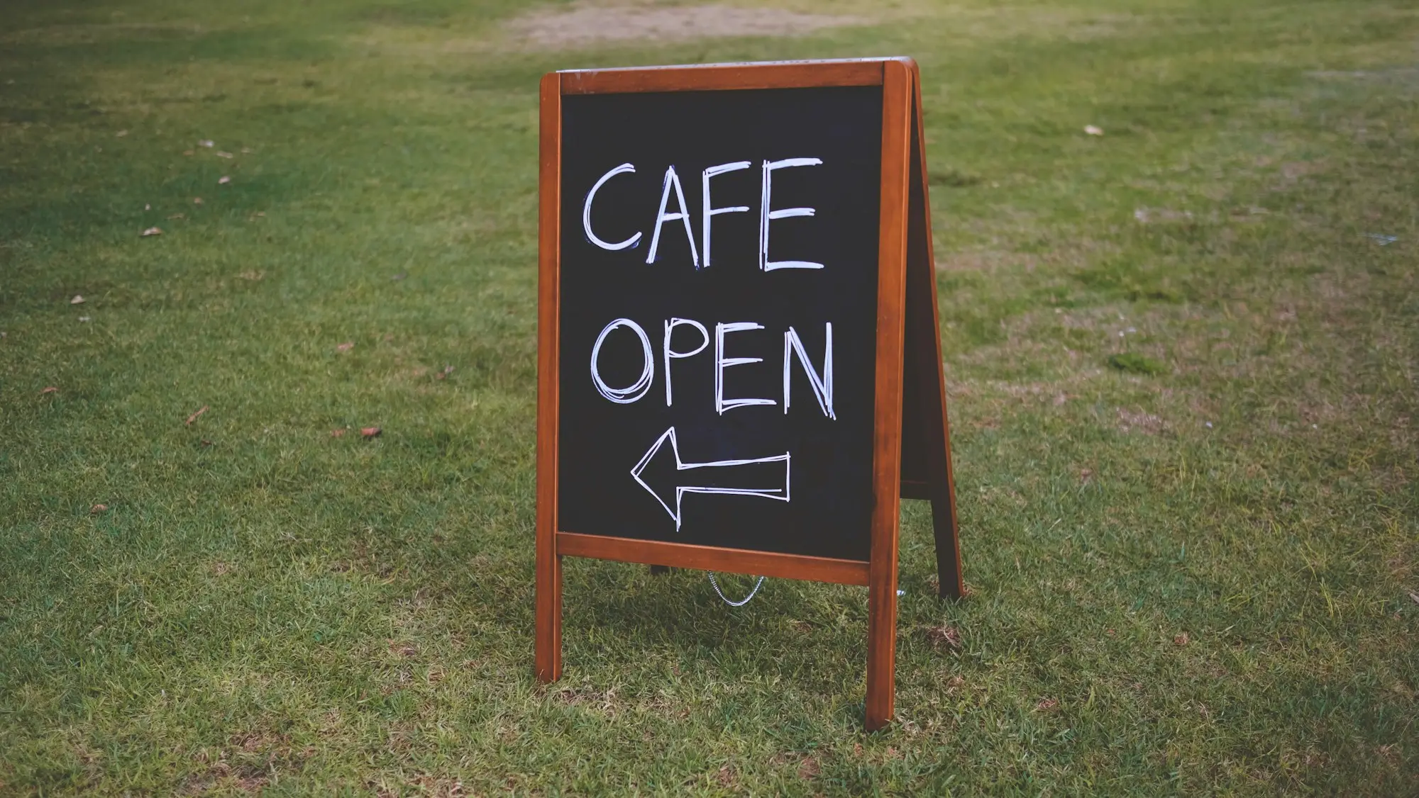 Chalkboard sign outside a newly opened cafe in Perth