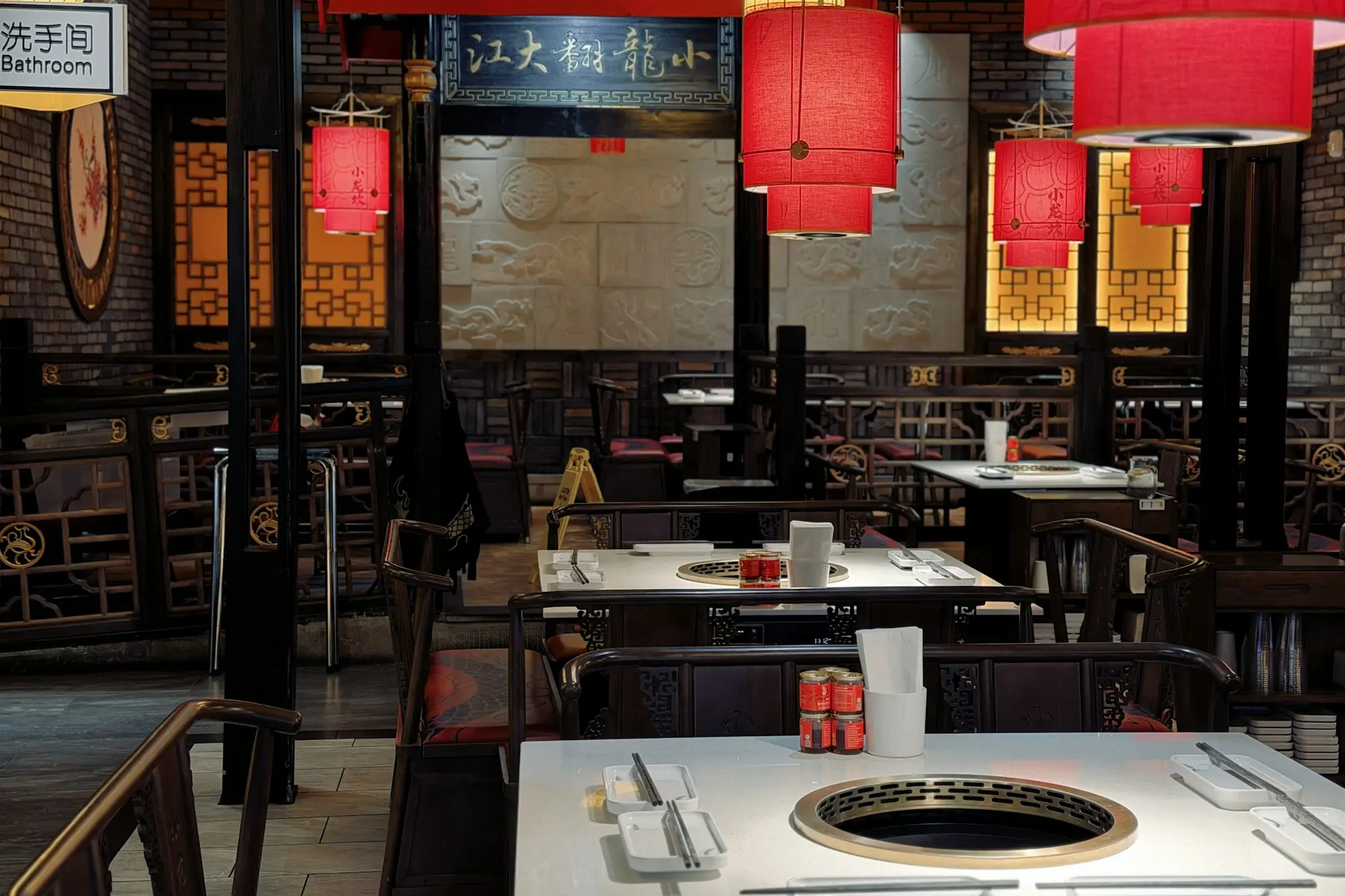 Warmly lit restaurant dining room set for evening service